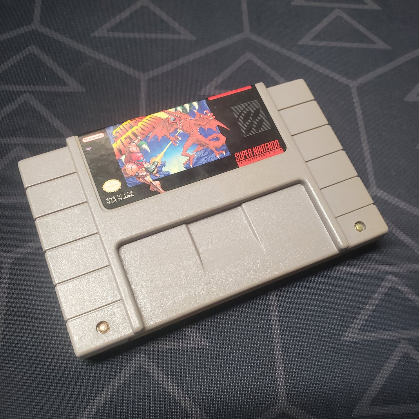 Image shows the front of the cartridge for the video game Super Metroid for the Super Nintendo