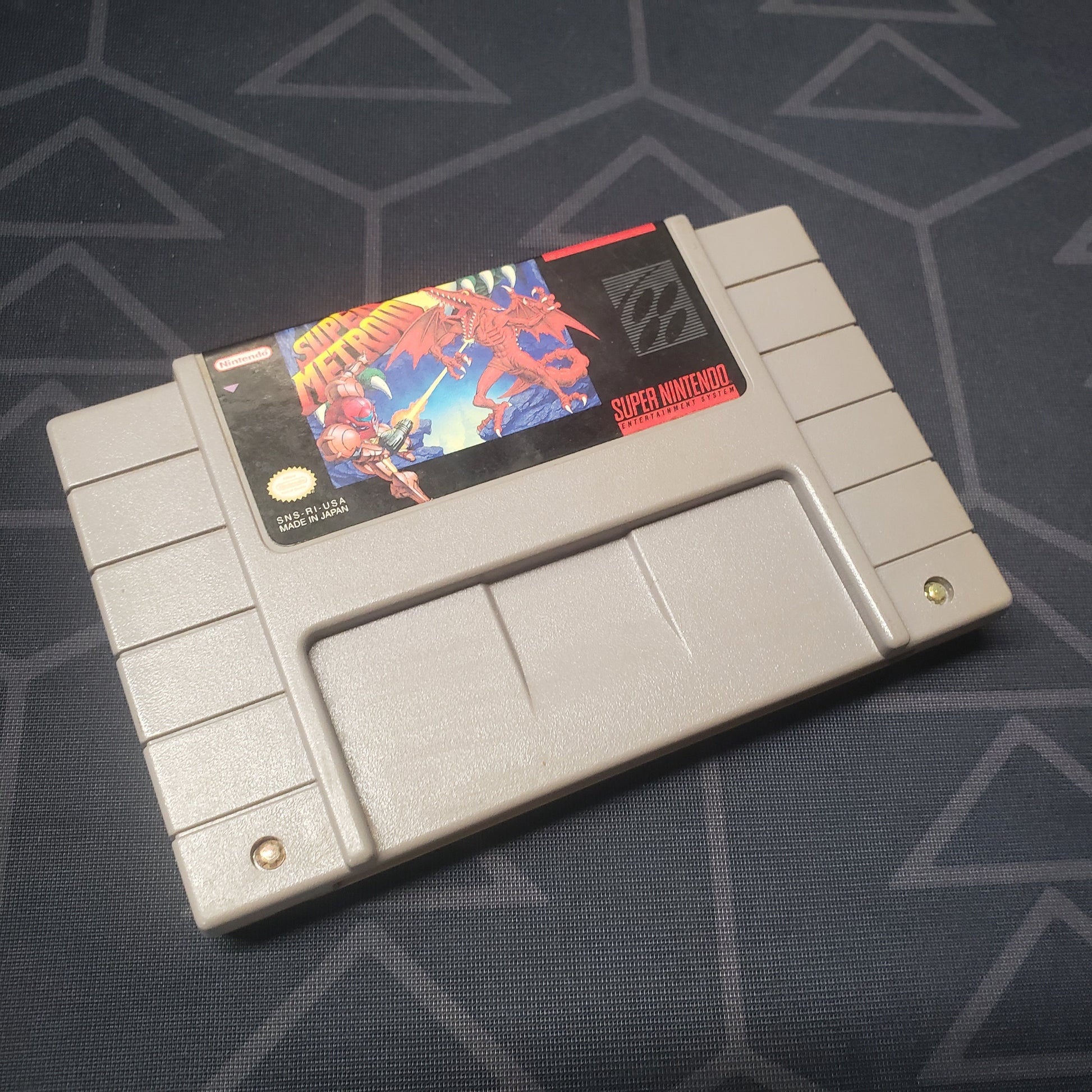 Image shows the front of the cartridge for the video game Super Metroid for the Super Nintendo