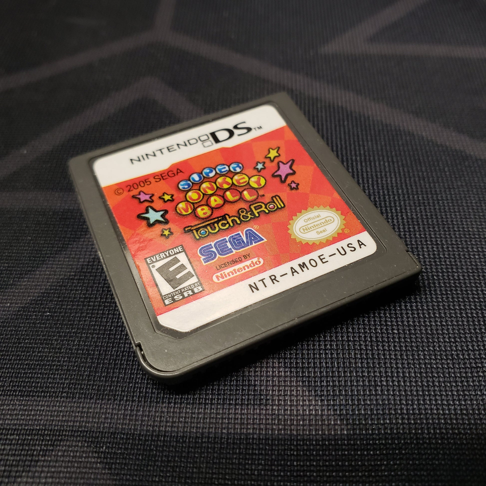 Image shows the front of the cartridge for the video game Super Monkey Ball: Touch and Roll for Nintendo DS