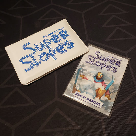 Image shows the front of the card wallet for the Super Slopes card game, with the Snow Report expansion sitting next to it