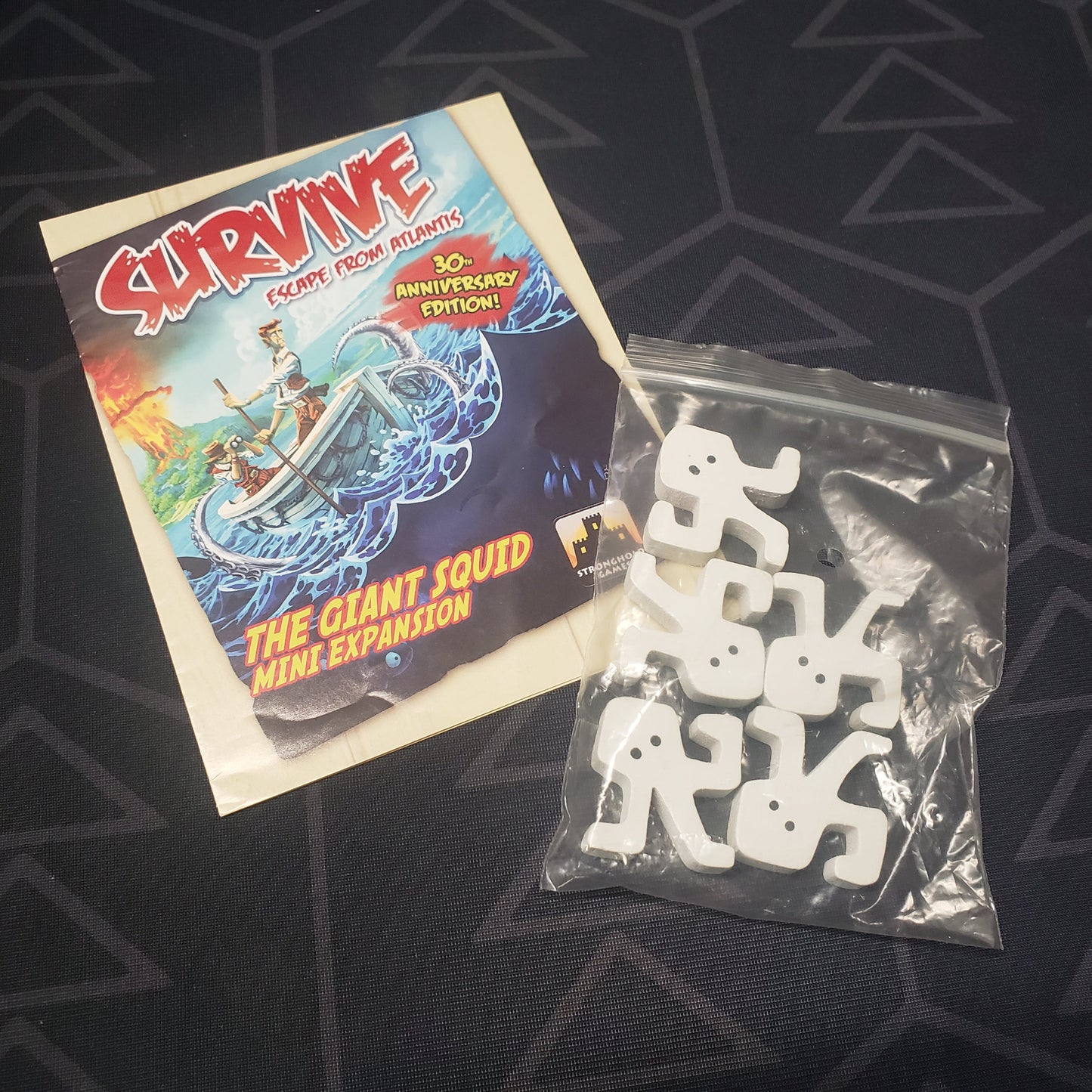 Image shows the instructions & components of the Giant Squid Mini expansion for the board game Survive: Escape from Atlantis!