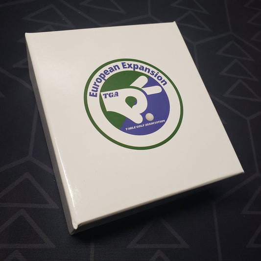 Image shows the front cover of the box of the European expansion for the board game Table Golf Association