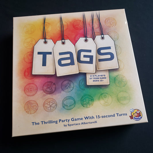 Image shows the front cover of the box of the TAGS board game