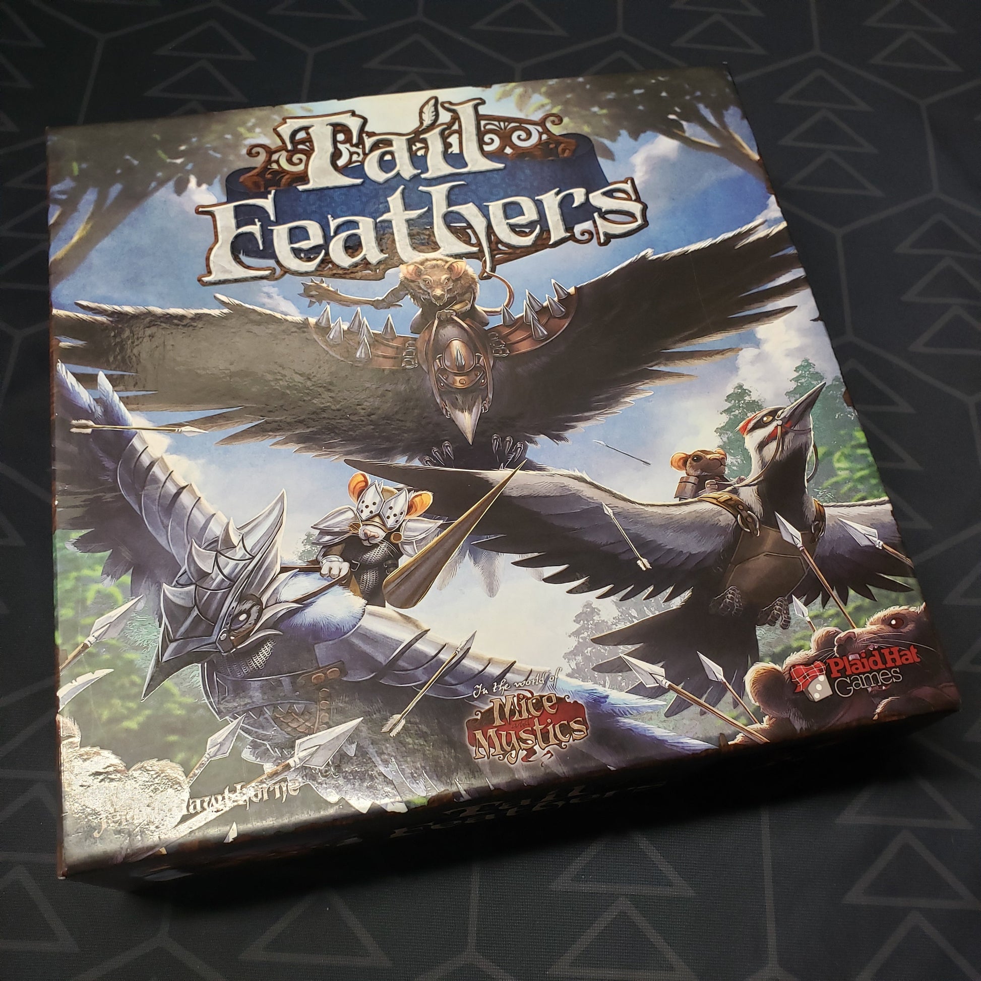Image shows the front cover of the box for the Tail Feathers board game