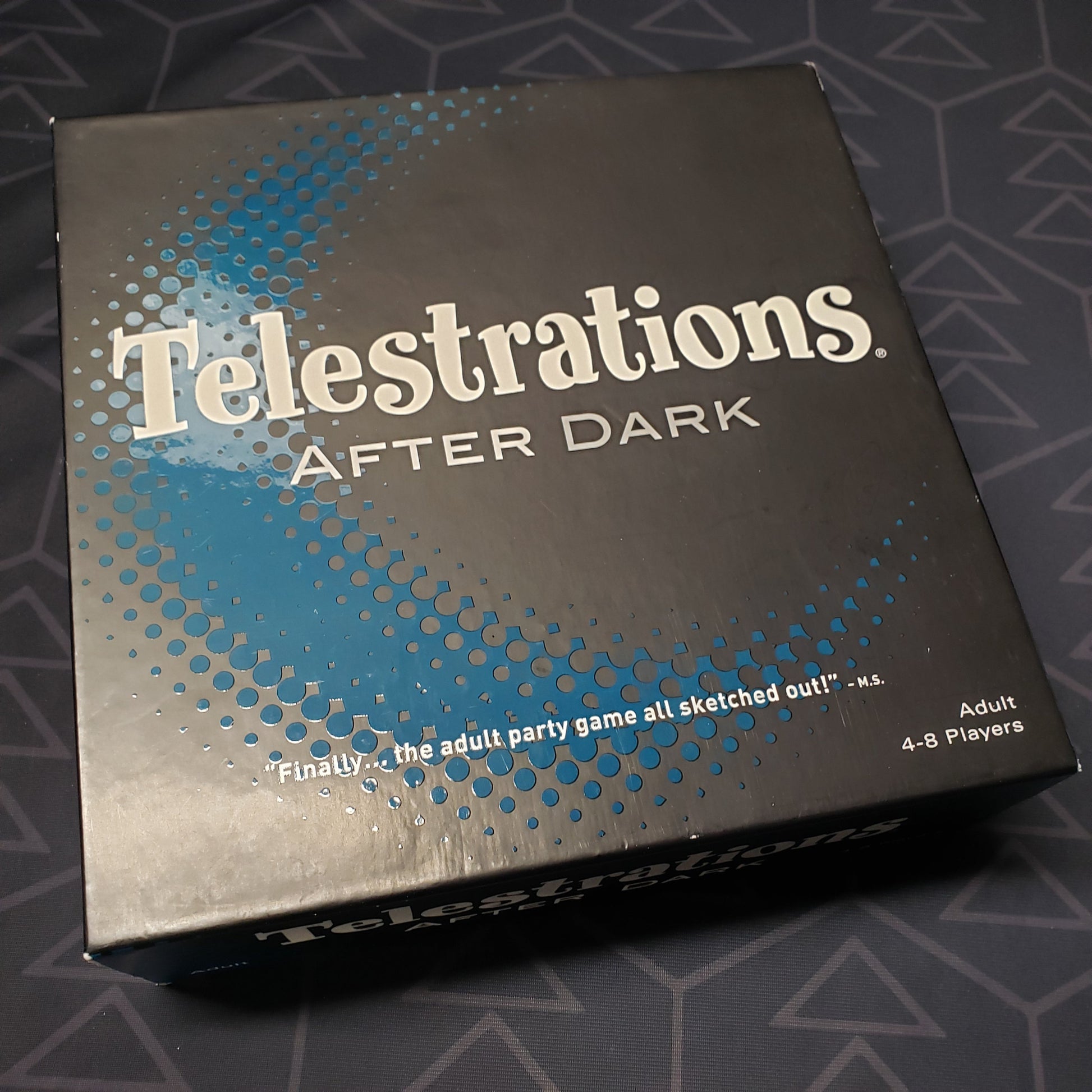 Image shows the front cover of the box for the Telestrations: After Dark board game