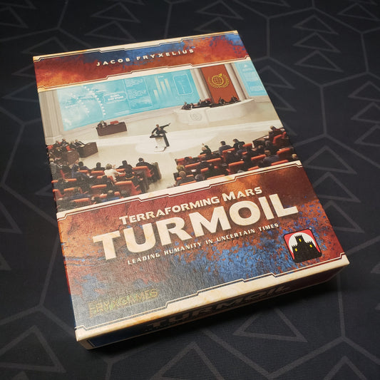 Image shows the front cover of the box of the Turmoil expansion for the board game Terraforming Mars