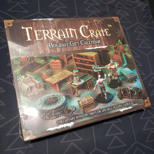 Image shows the front cover of the box for the Terrain Crate: Holiday gaming Gift Calendar