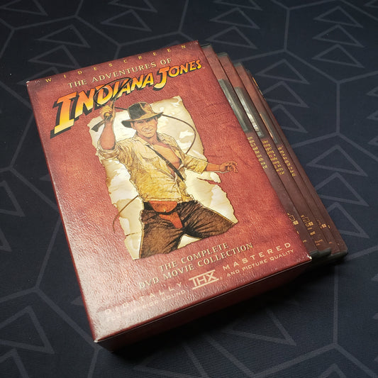 Image shows the outer box with four fanned-out disc cases for the three-movie set The Adventures of Indiana Jones on DVD