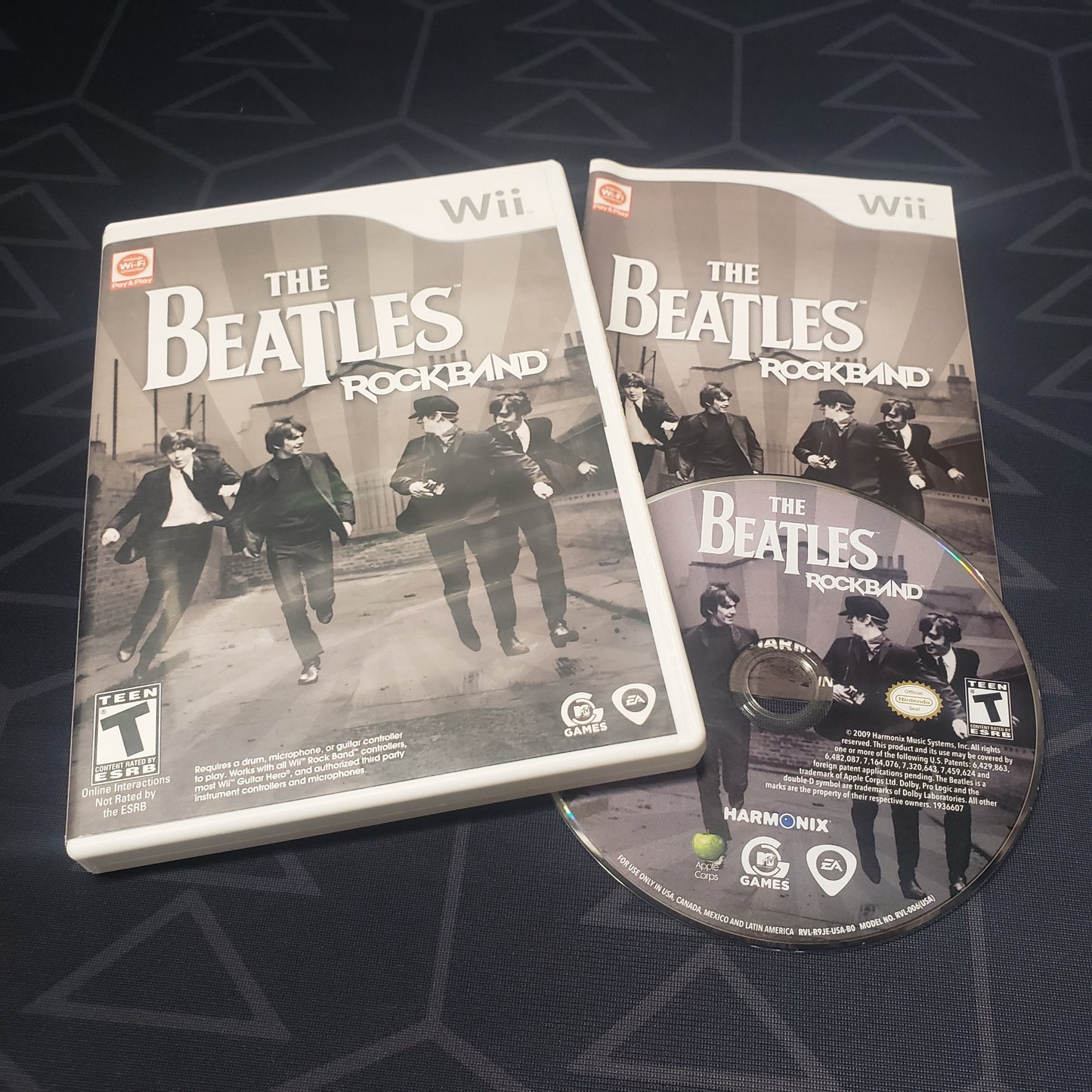 Image shows the case, manual & disc for the video game The Beatles: Rock Band for Nintendo Wii