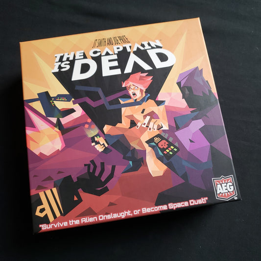 Image shows the front cover of the box of the Captain is Dead board game