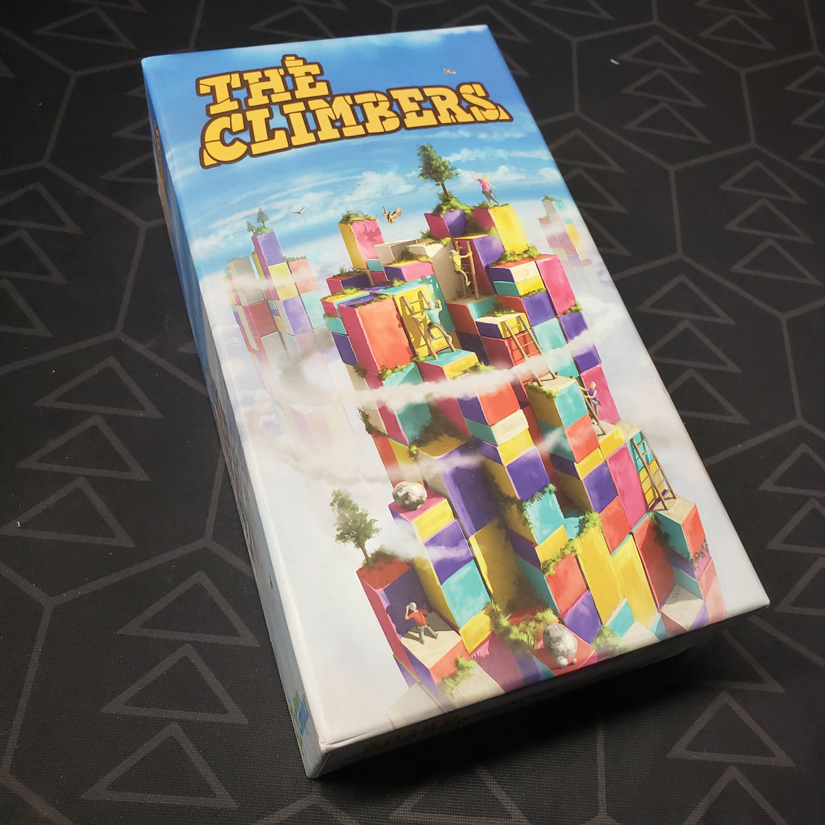 Image shows the front cover of the box for the board game The Climbers