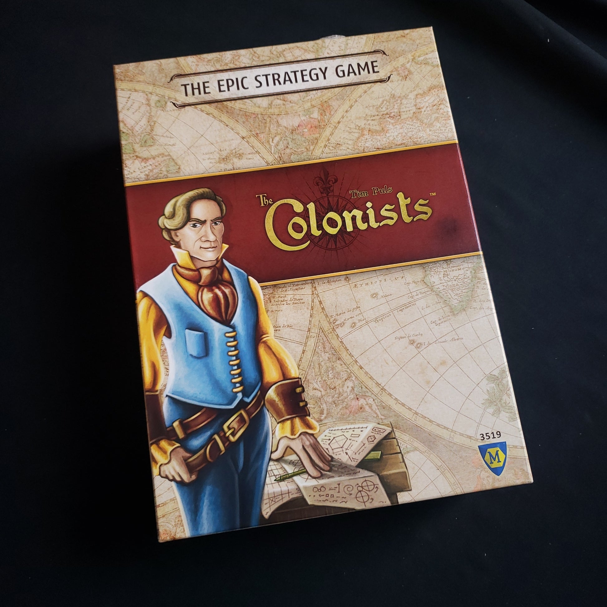 Image shows the front cover of the box of the Colonists board game