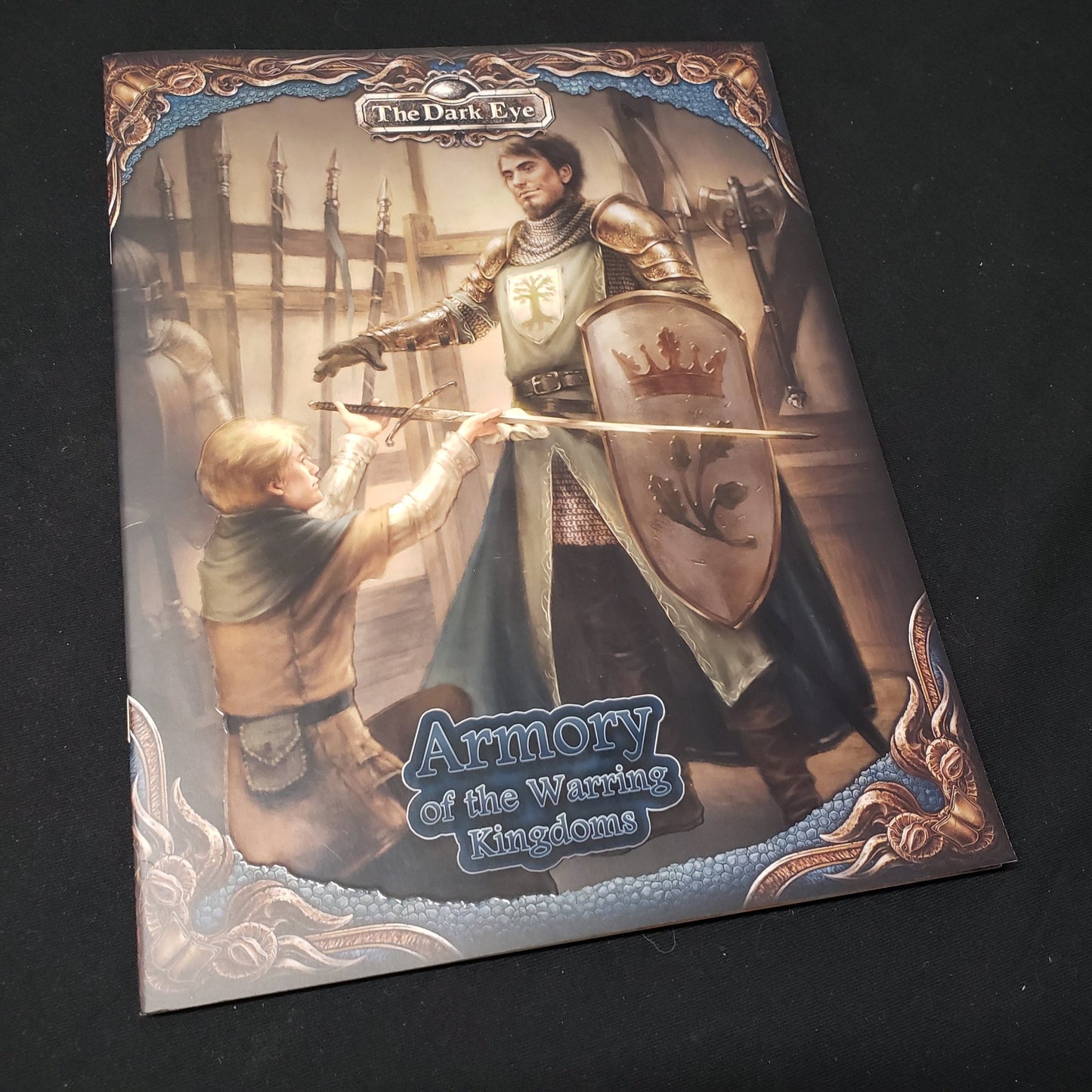 Image shows the front cover of the Armory of the Warring Kingdoms book for the roleplaying game The Dark Eye