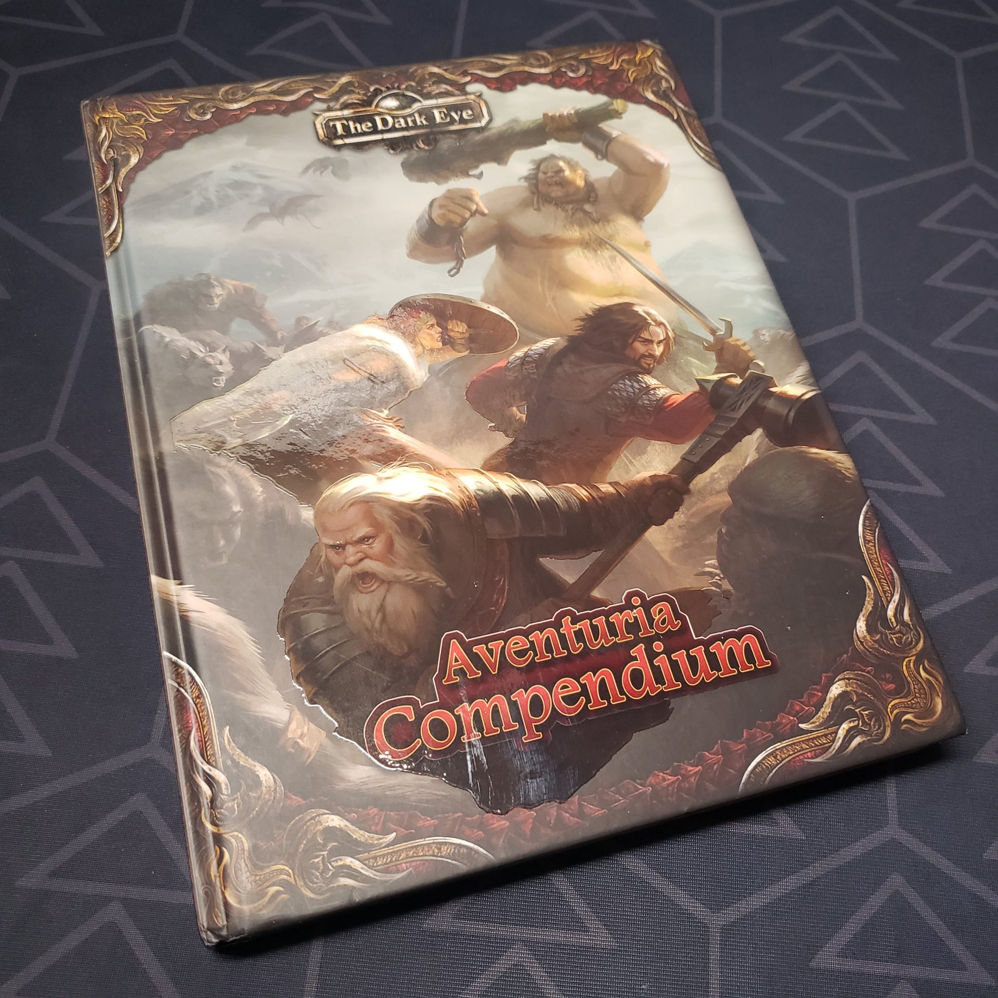 Image shows the front cover of the Aventuria Compendium book for the Dark Eye roleplaying game