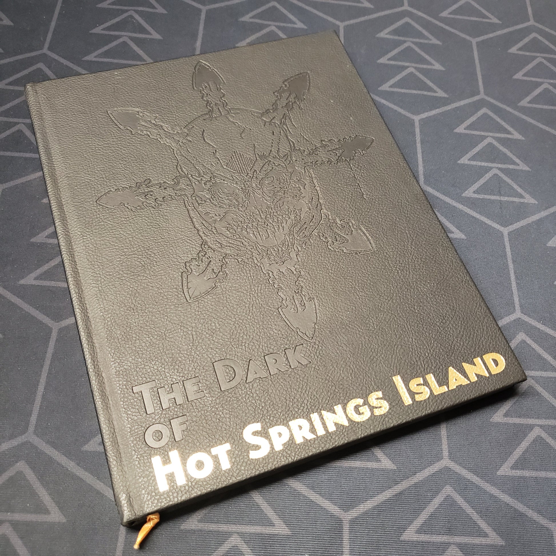 Image shows the front cover of the The Dark of Hot Springs Island roleplaying game book