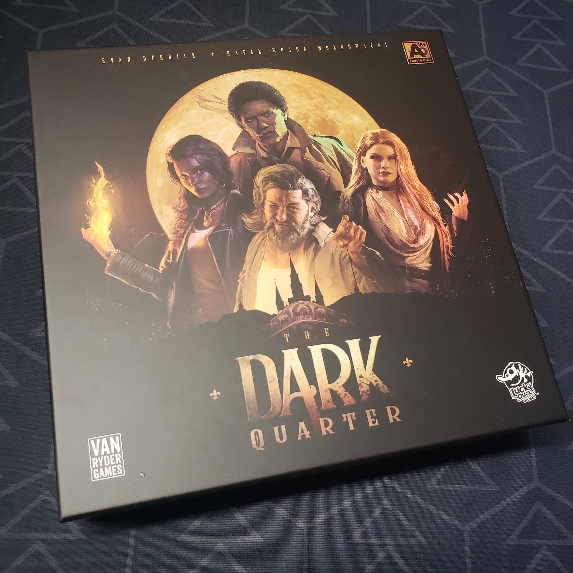 Image shows the front cover of the box for the board game The Dark Quarter