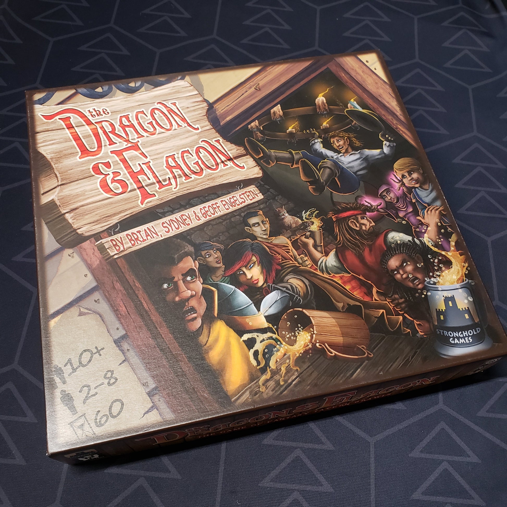 Image shows the front cover of the box for the Dragon & Flagon board game