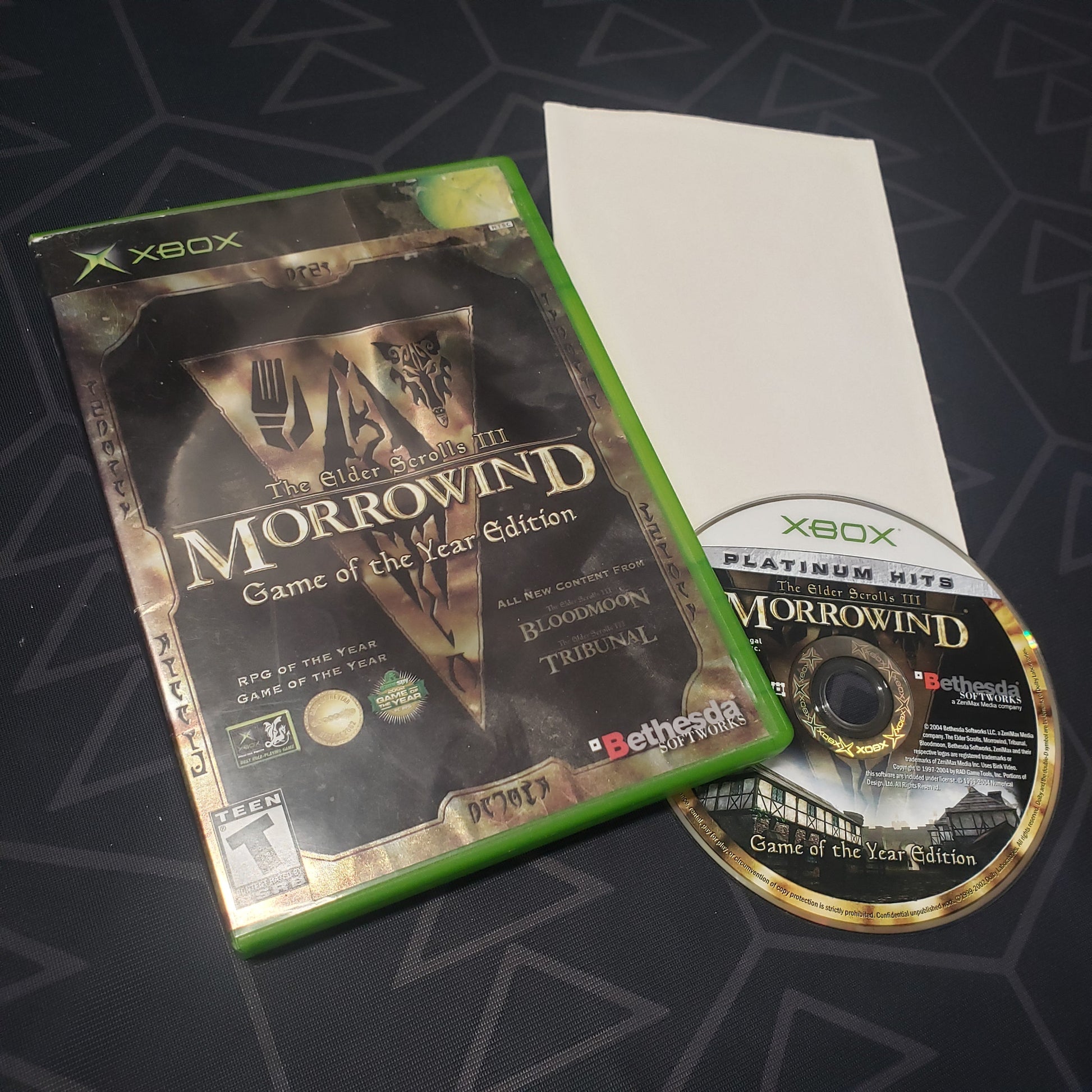 Image shows the case, folded up poster and disc for the Game of the Year edition video game The Elder Scrolls III: Morrowind for the original Xbox
