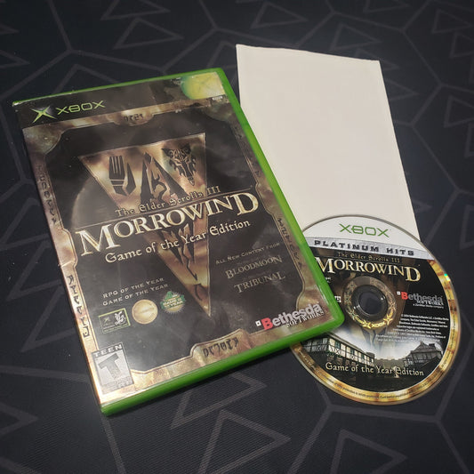 Image shows the case, folded up poster and disc for the Game of the Year edition video game The Elder Scrolls III: Morrowind for the original Xbox