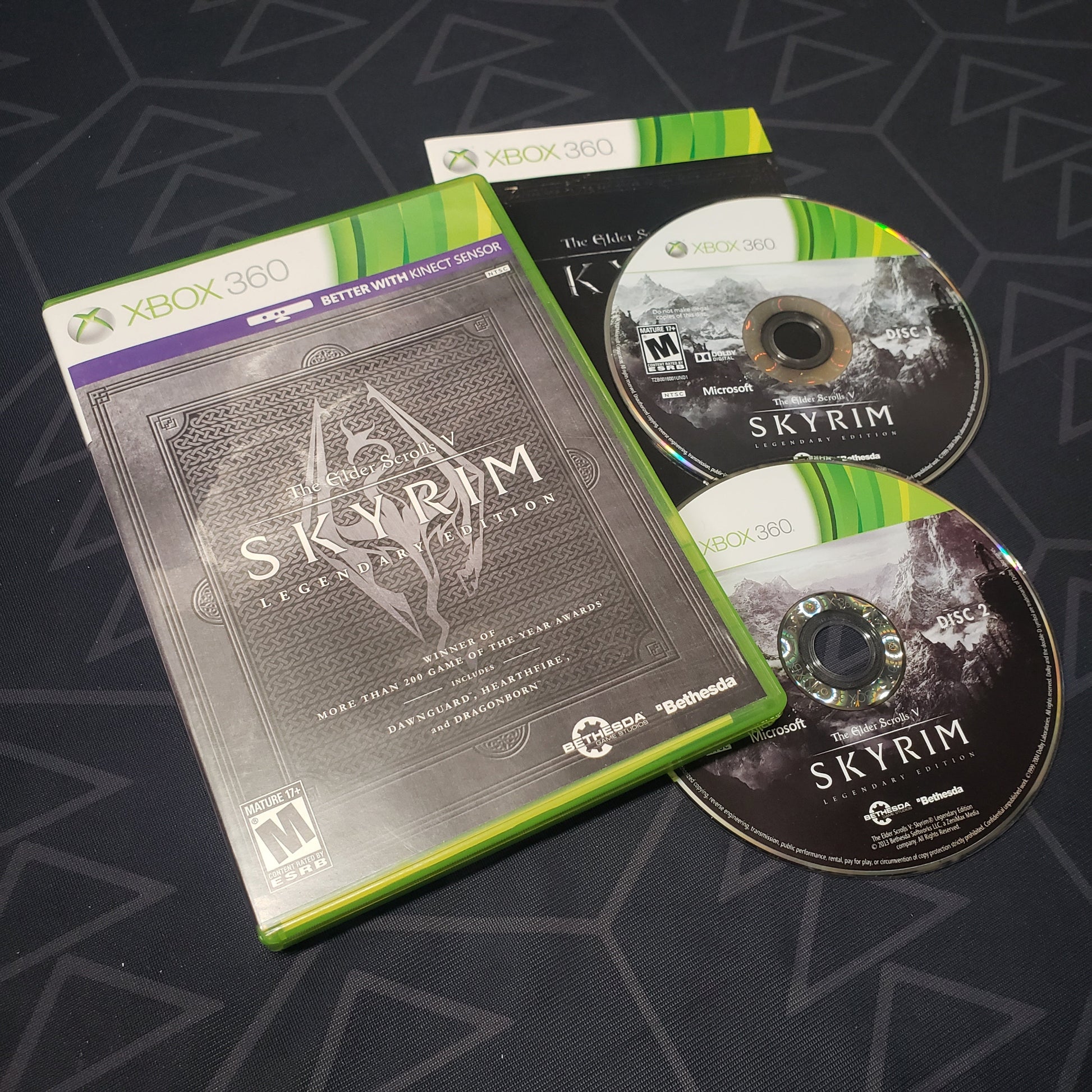 Image shows the case, manual and two discs for the Legendary Edition of the video game The Elder Scrolls V: Skyrim for Xbox 360