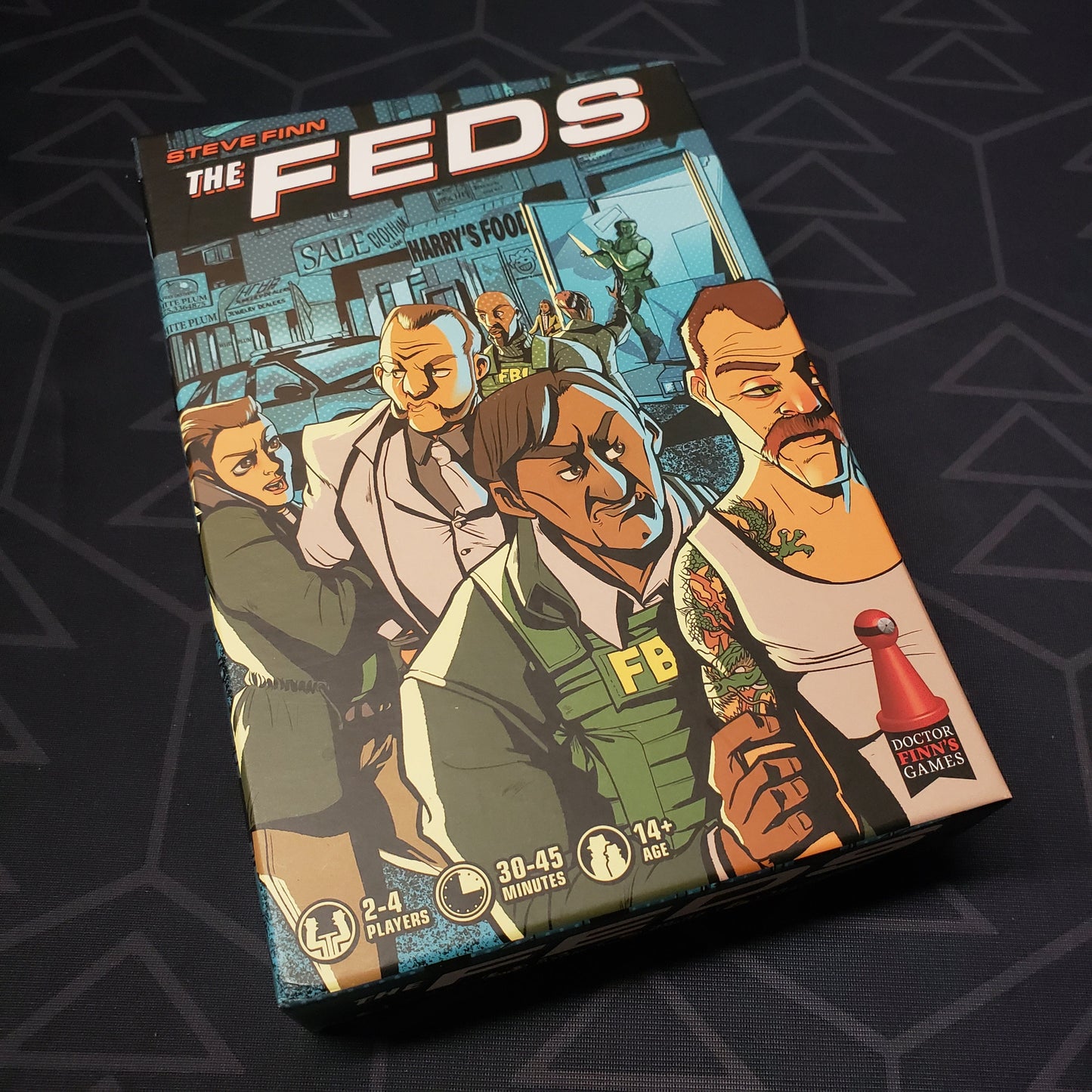 Image shows the front cover of the box for the card game The Feds