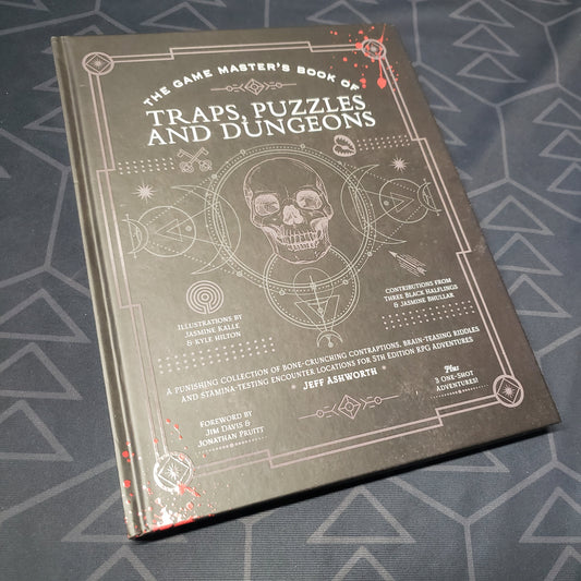 Image shows the front cover of the Game Master's Book of Traps, Puzzles and Dungeons roleplaying game book