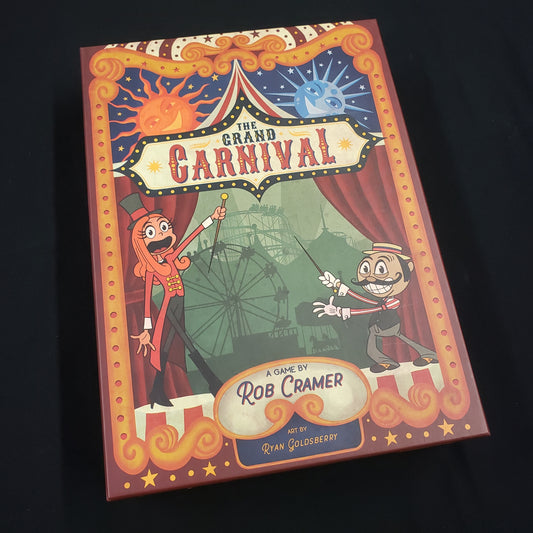 Image shows the front cover of the box of the Grand Carnival board game