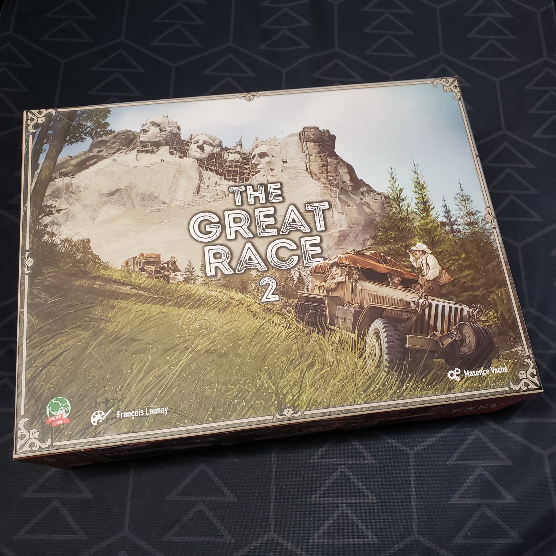 Image shows the front cover of the box for the board game The Great Race 2