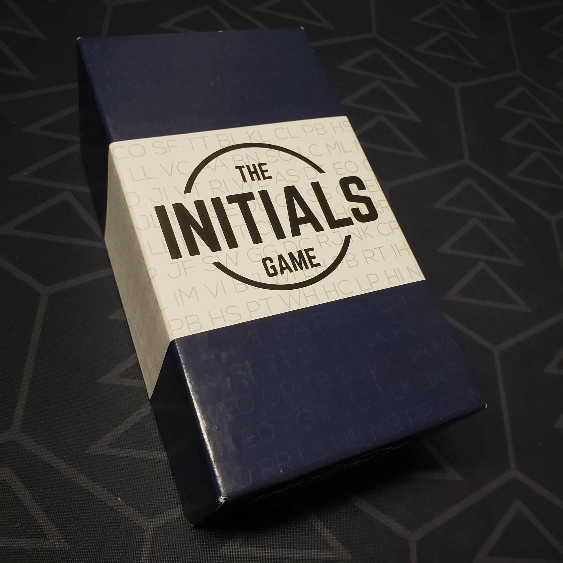 Image shows the front cover of the box for the Initials Game card game