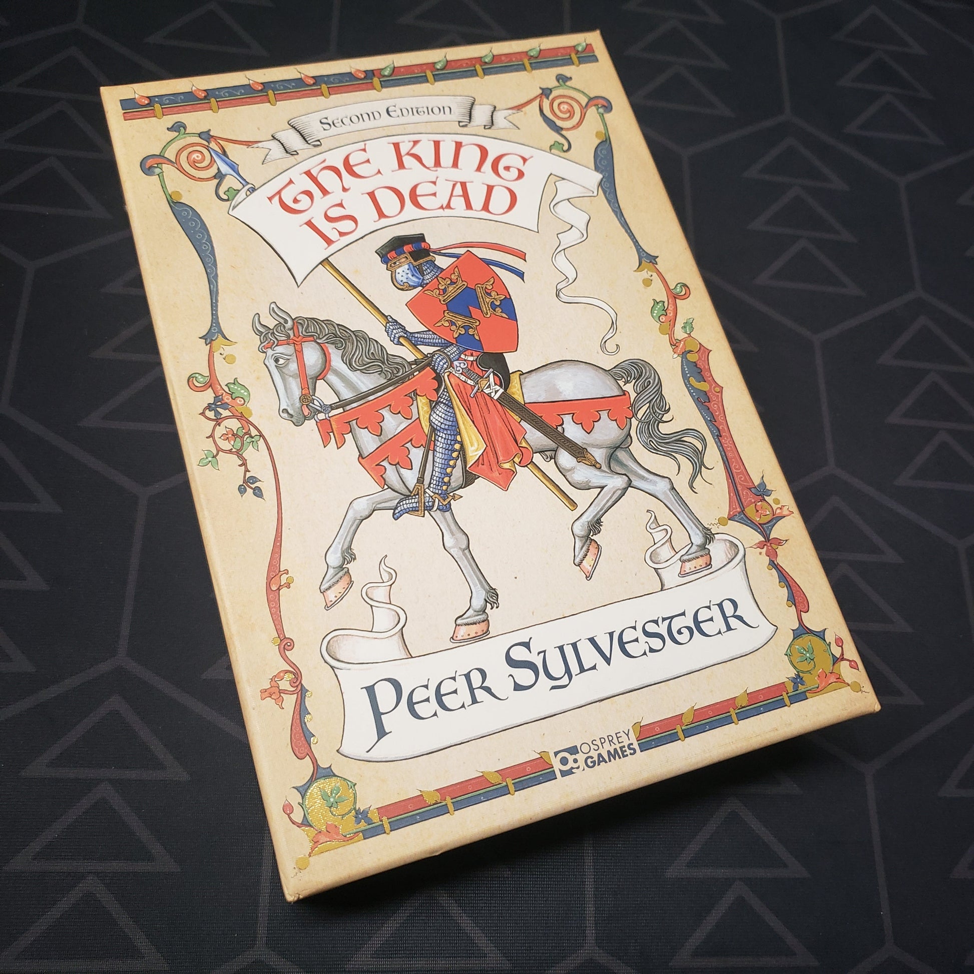 Image shows the front cover of the box for the The King is Dead (Second Edition) board game