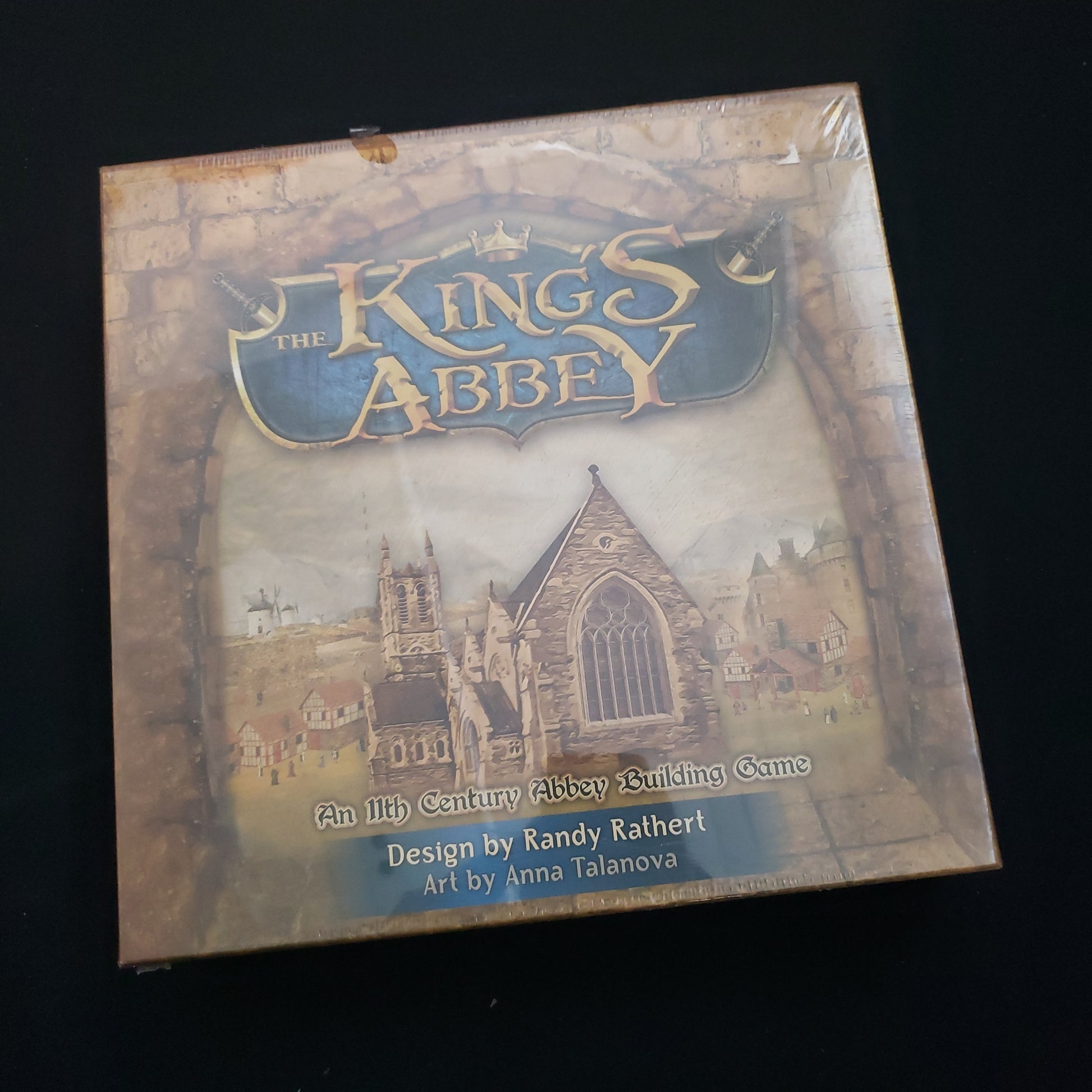 Image shows the front cover of the box of the King's Abbey board game