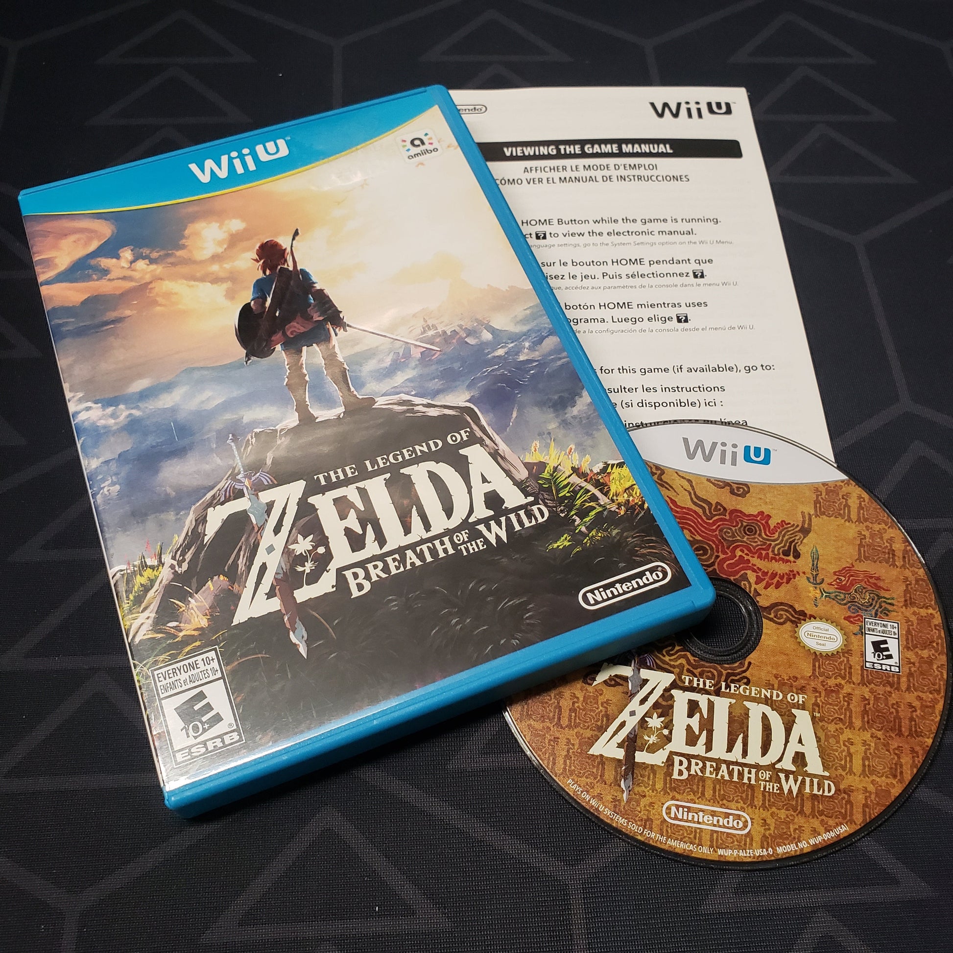 Image shows the case, manual and disc for the video game The Legend of Zelda: Breath of the Wild for Nintendo Wii U