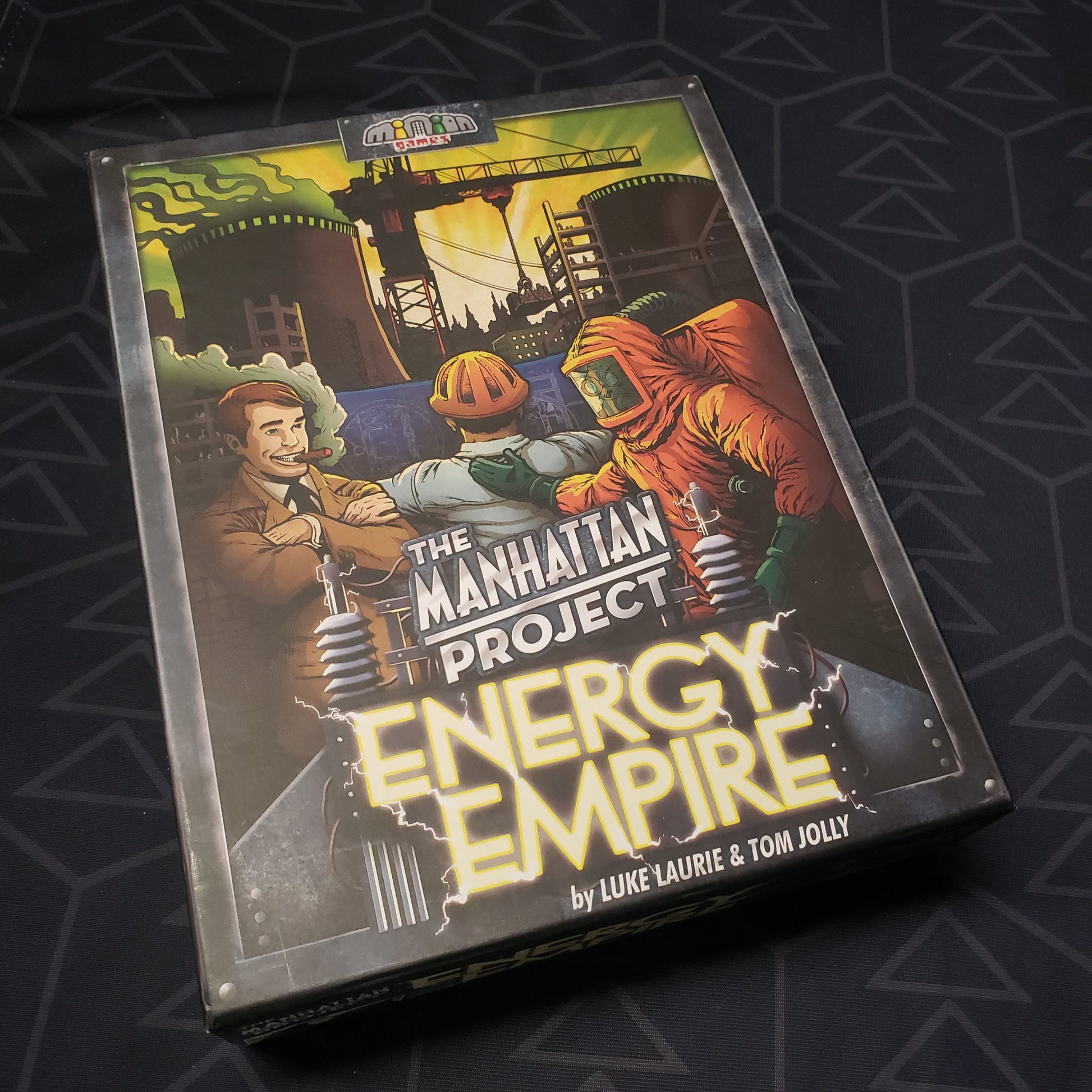 Image shows the front cover of the box for the Manhattan Project: Energy Empire board game