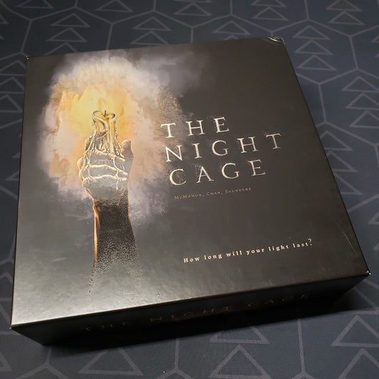 Image shows the front cover of the box of the Night Cage board game