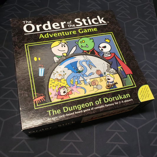 Image shows the front cover of the box for the Order of the Stick Adventure Game: The Dungeon of Dorukan card game