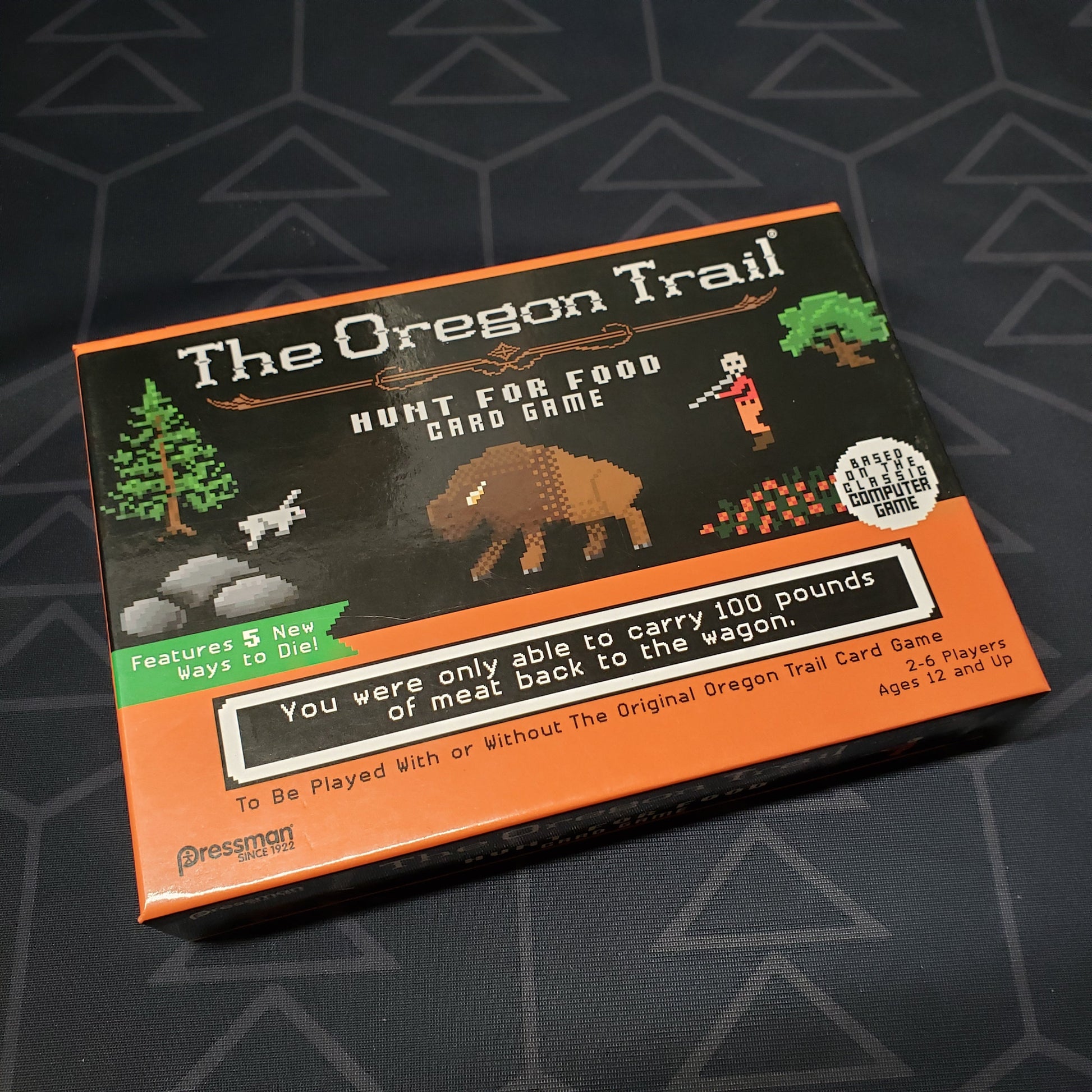 Image shows the front cover of the box of The Oregon Trail: Hunt for Food Card Game