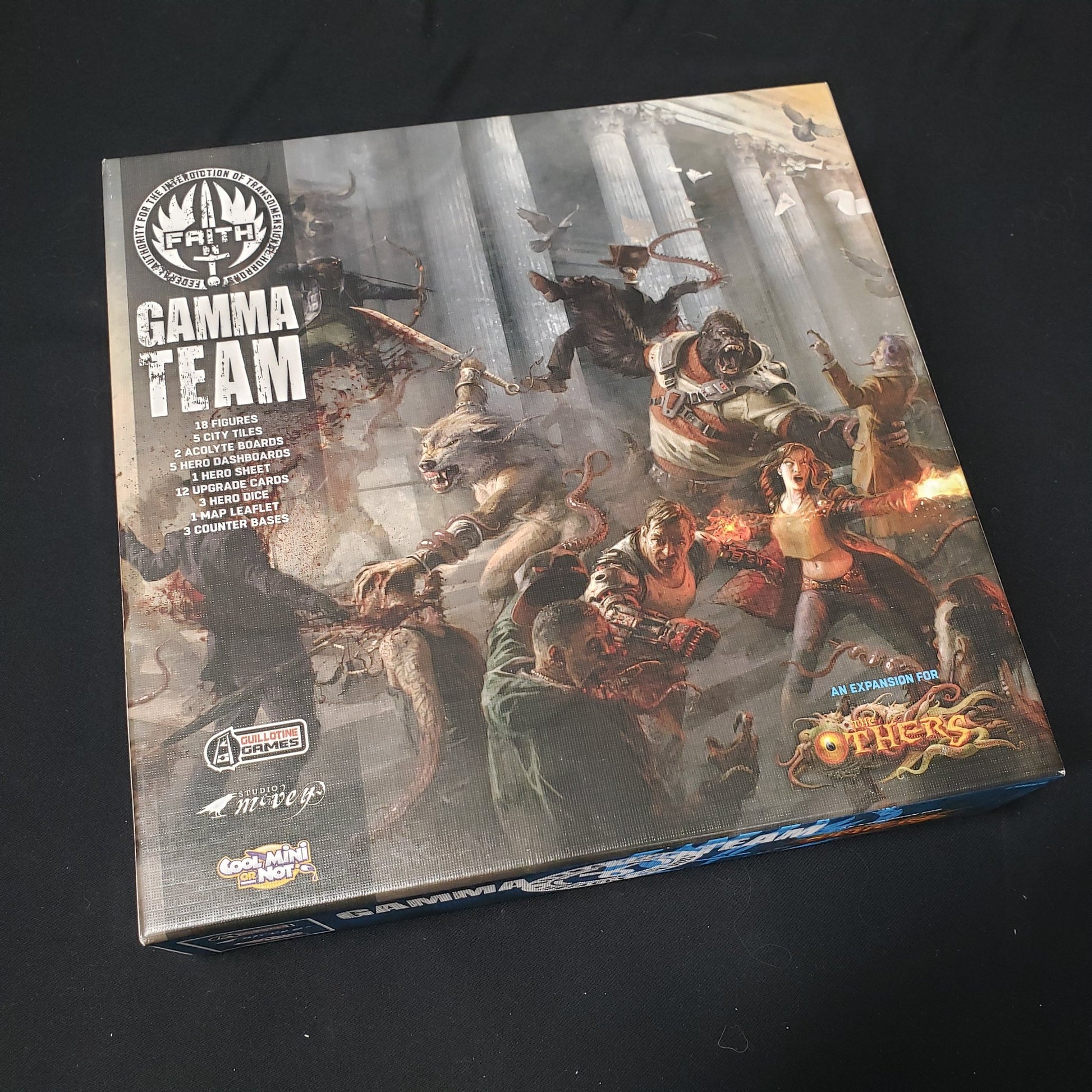 Image shows the front cover of the box of the Gamma Team expansion for the board game The Others