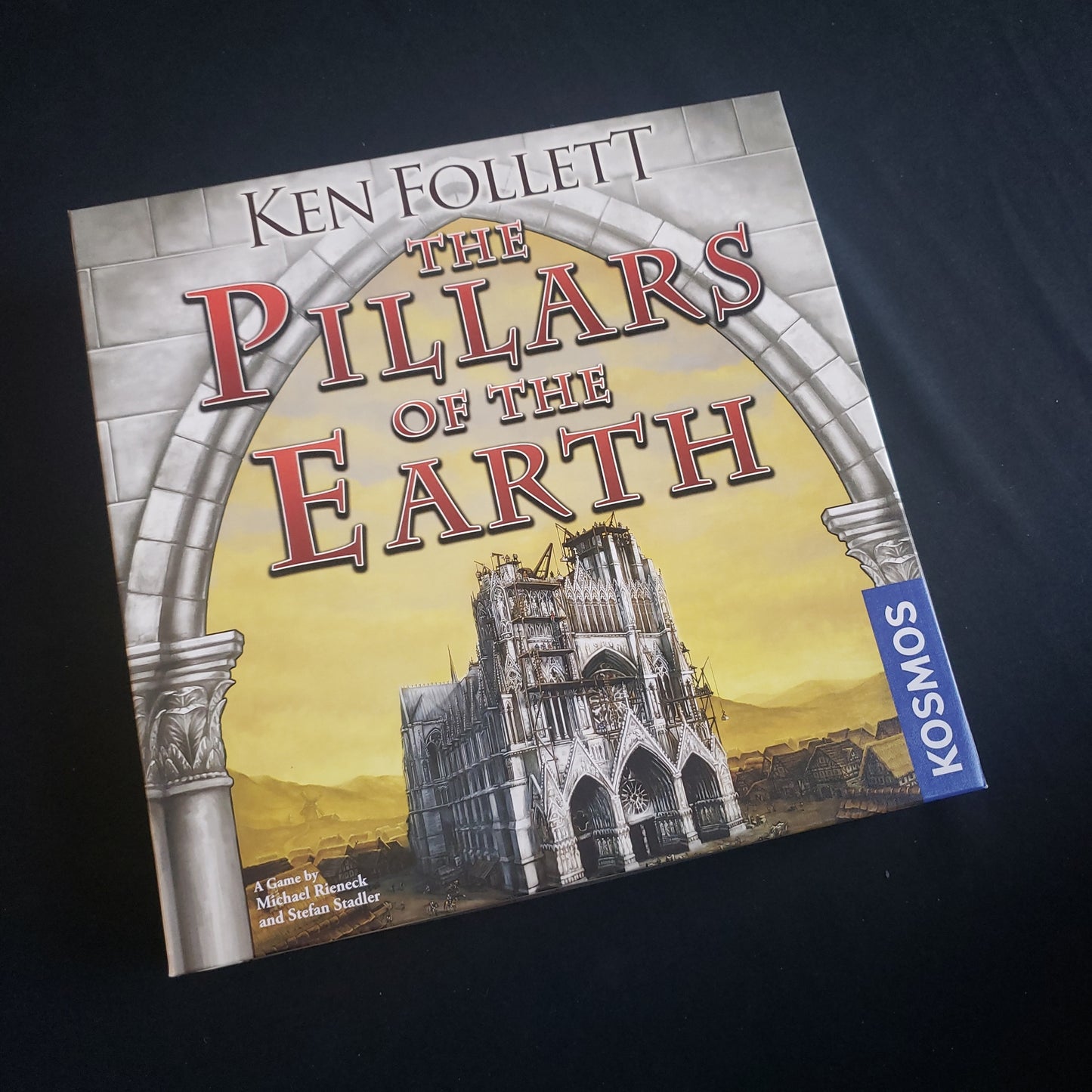 Image shows the front cover of the box of the Pillars of the Earth board game