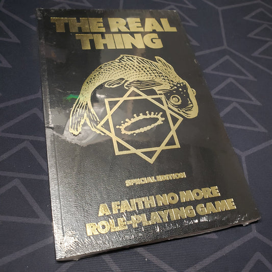 Image shows the front cover of the special edition core rulebook for the roleplaying game The Real Thing