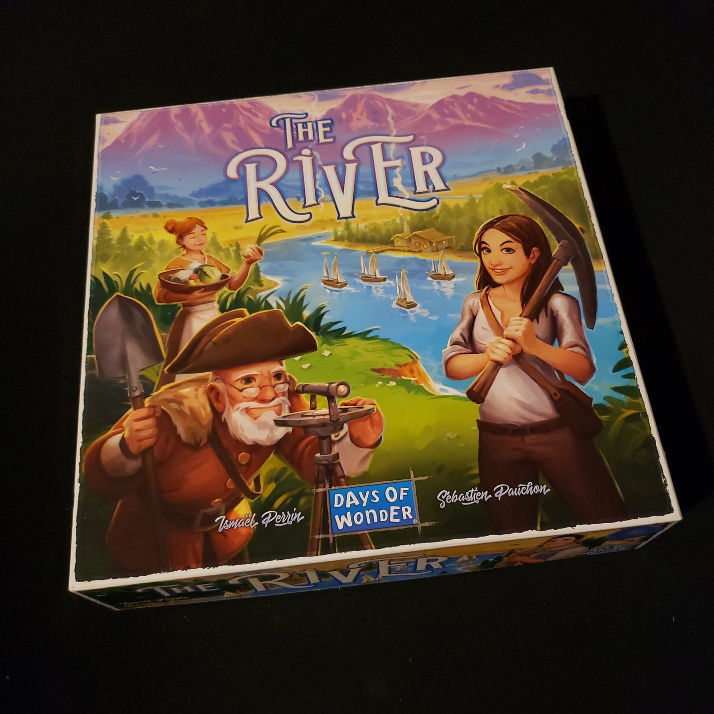 Image shows the front cover of the box of the River board game