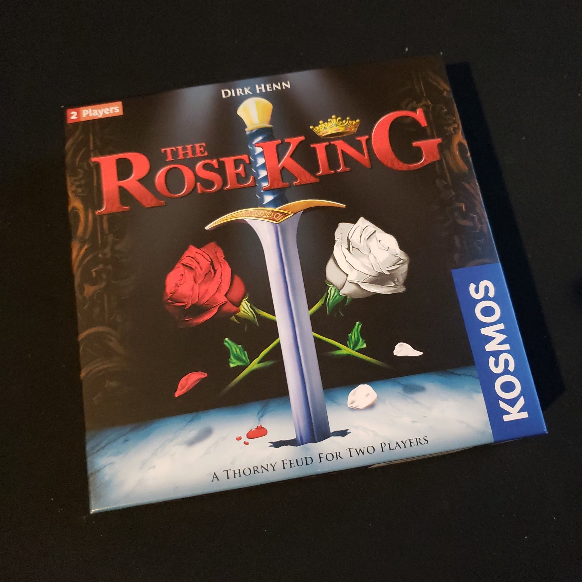 Image shows the front cover of the box of the Rose King board game