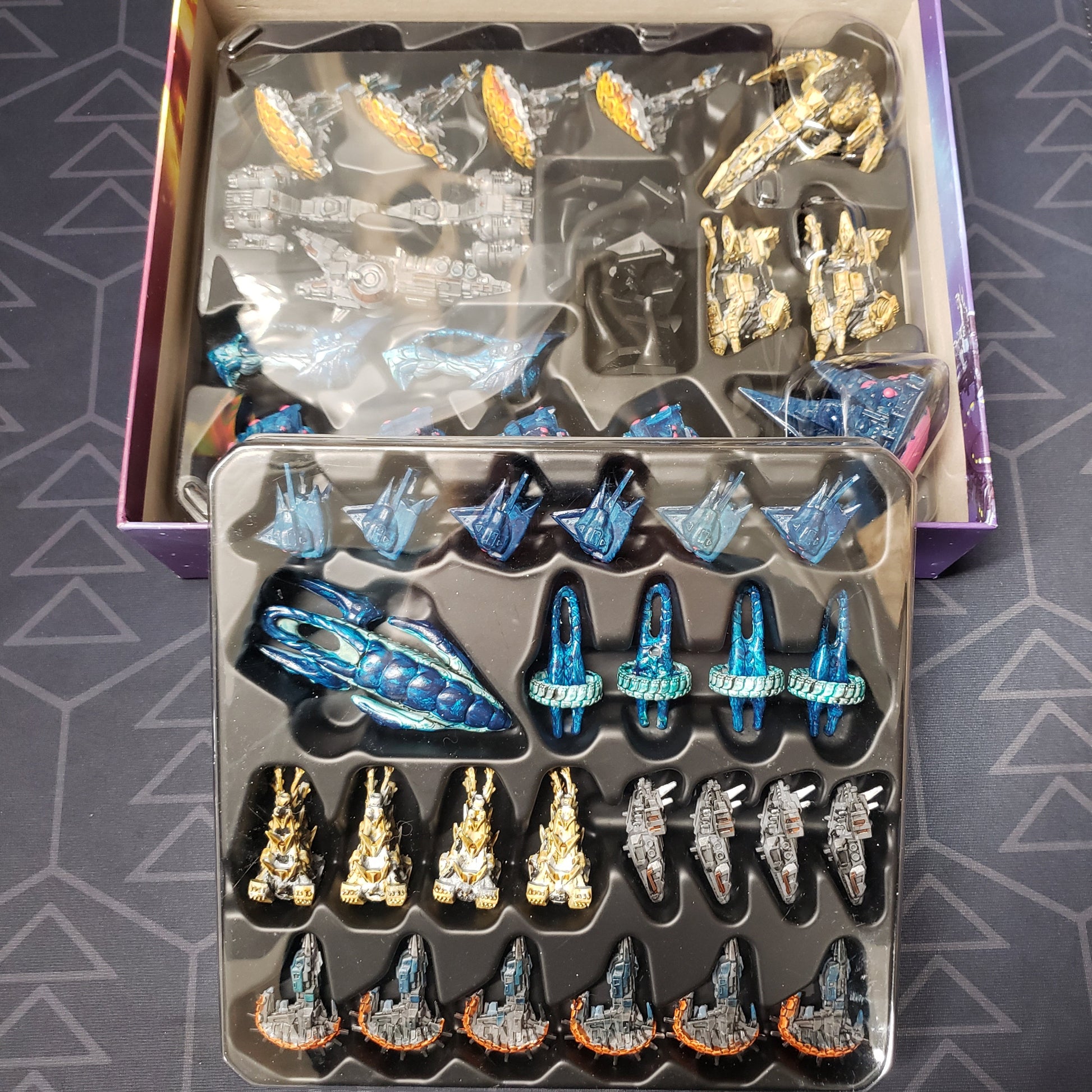 Image shows two trays of painted miniatures for the Ships of Akarios minis expansion
