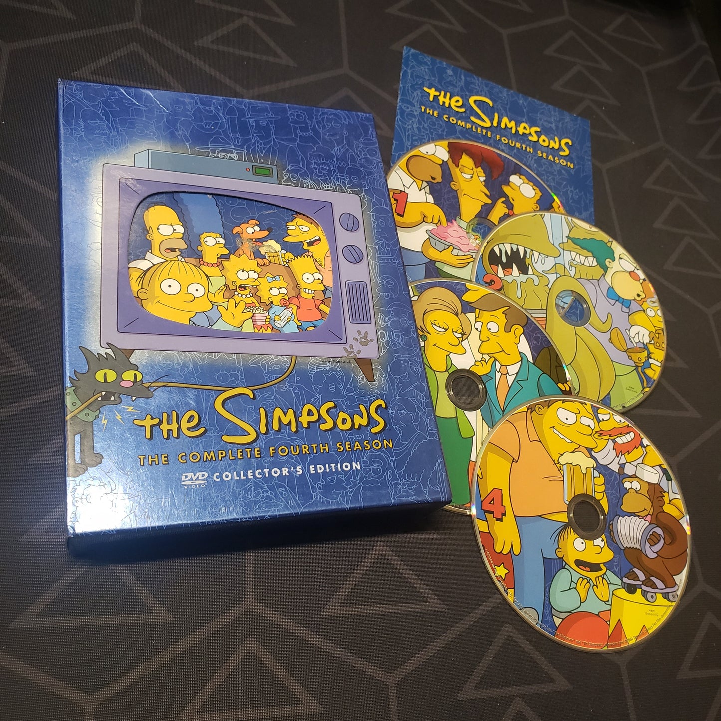 Image shows the case, insert & four discs for the fourth season of The Simpsons on DVD