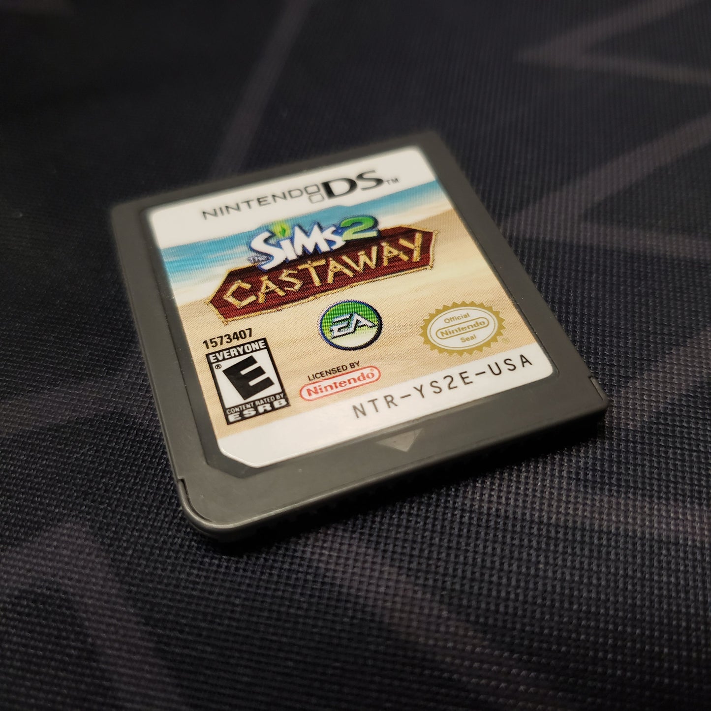 Image shows the front of the cartridge for the video game The Sims 2: Castaway for Nintendo DS