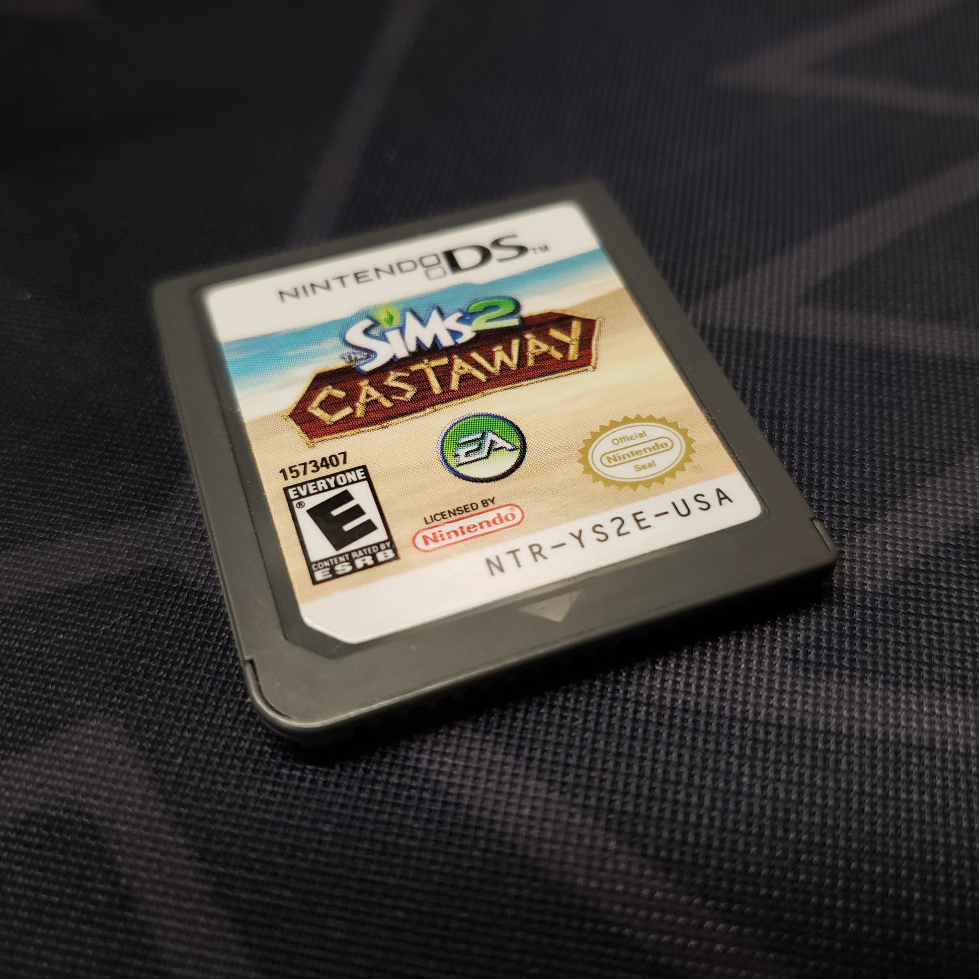Image shows the front of the cartridge for the video game The Sims 2: Castaway for Nintendo DS