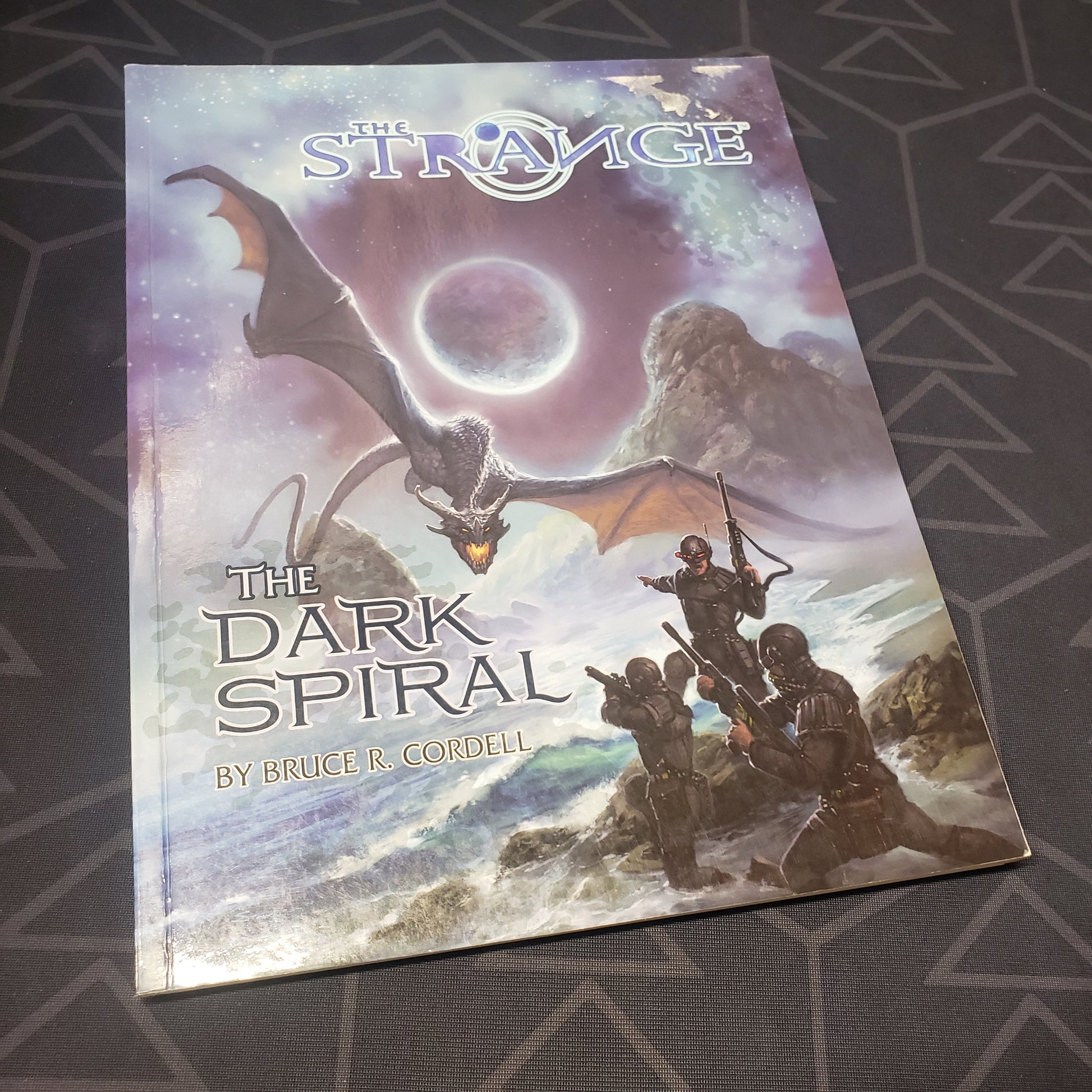 Image shows the front cover of the Dark Spiral book for the roleplaying game The Strange