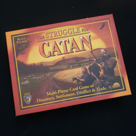Image shows the front cover of the box of the Struggle For Catan card game