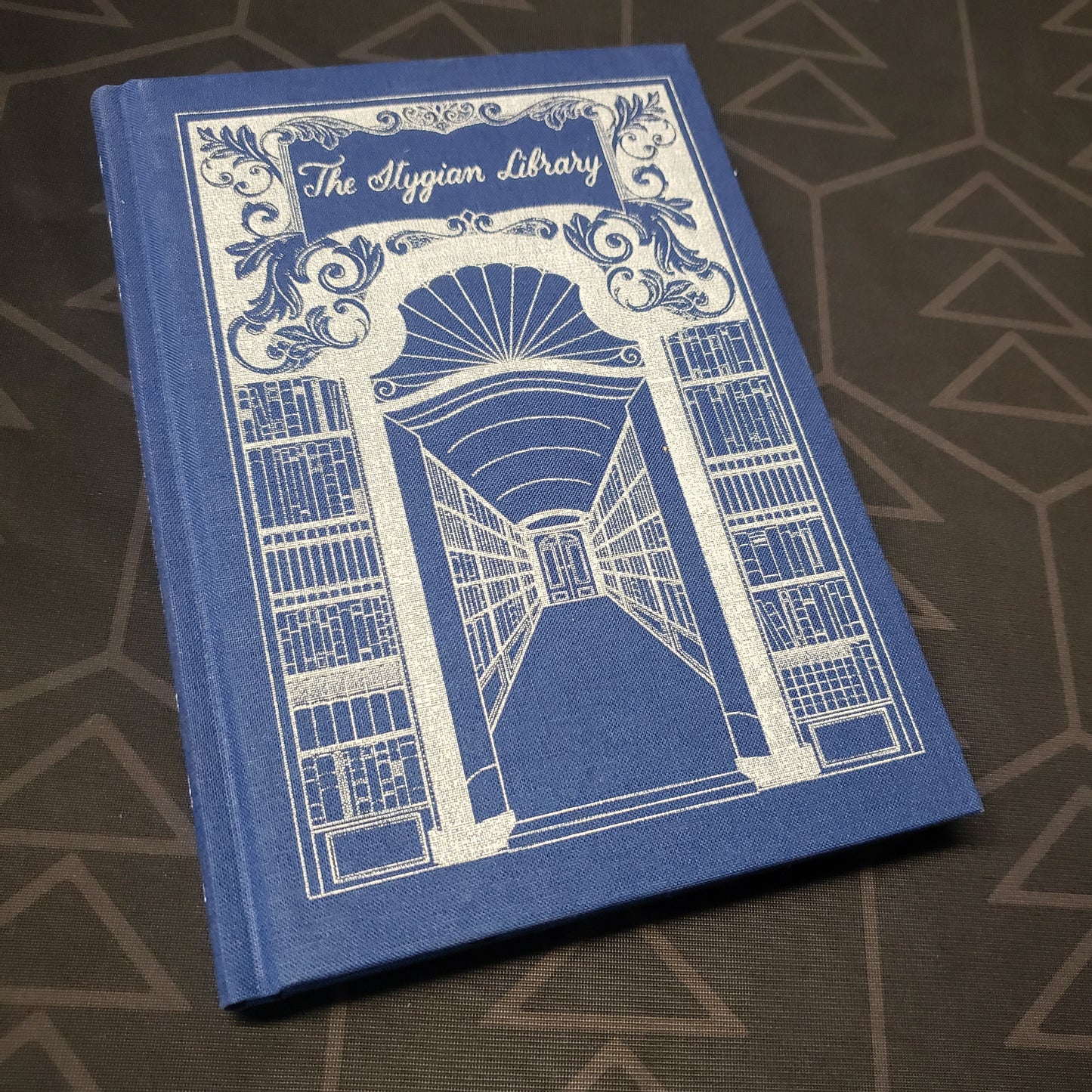 Image shows the front cover of the 2020 Remastered Edition of the Stygian Library roleplaying game book