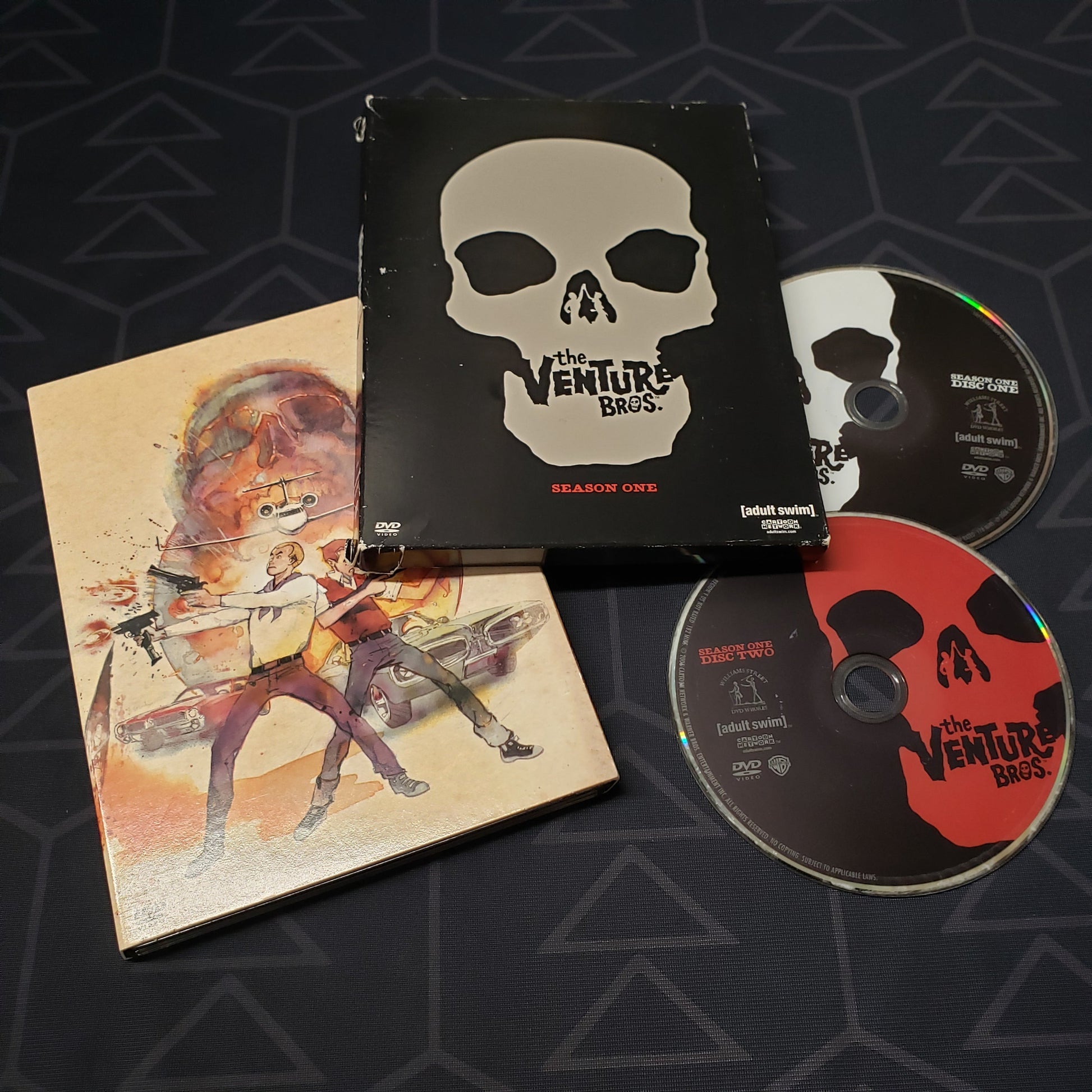 Image shows the case, outer box & two discs for the first season of The Venture Bros. on DVD