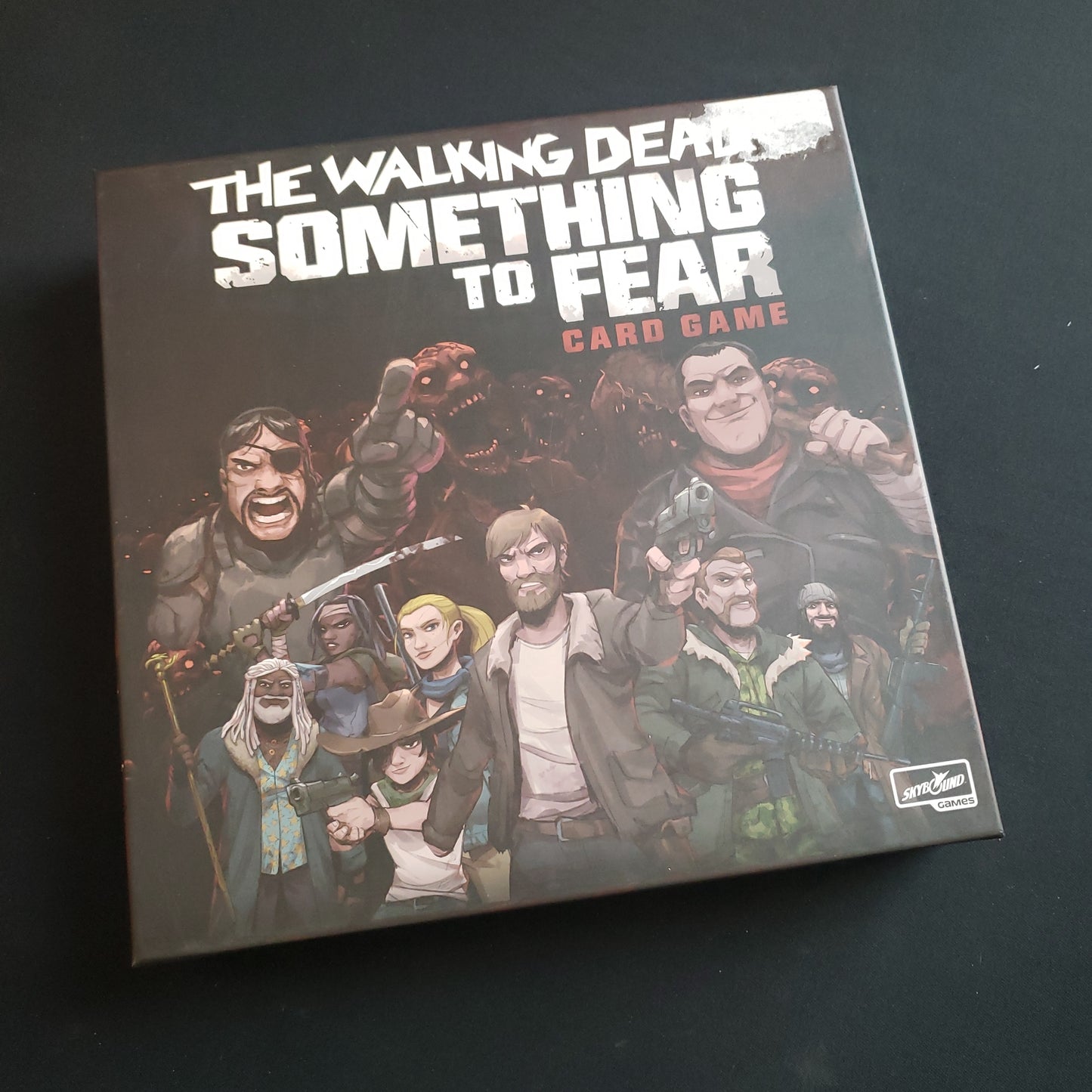 Image shows the front cover of the box of the Walking Dead: Something to Fear card game